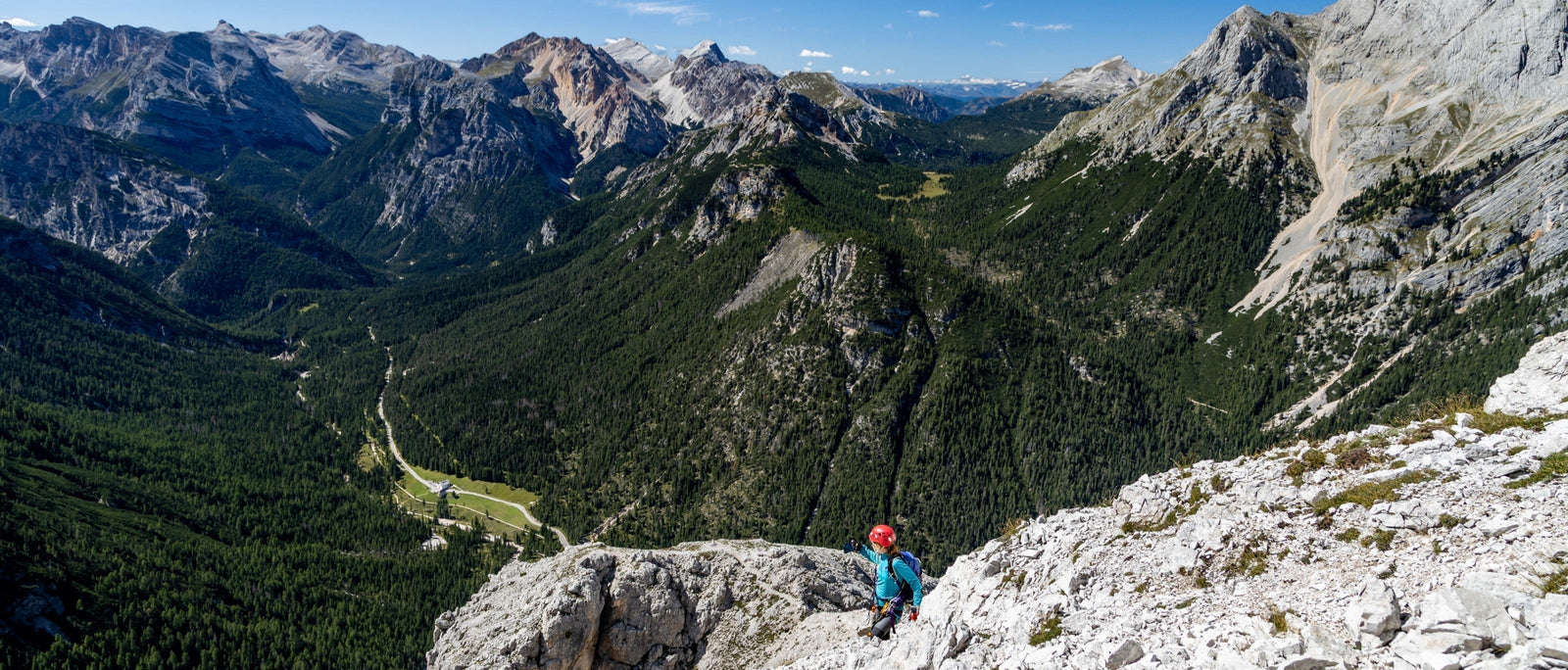 A sea of jagged mountains in the Dolomites, seen from the final stretch of the climb to the summit of Punta Ovest del Forame from Cimabanche.